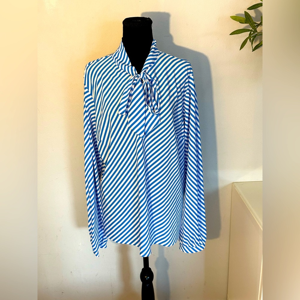 A NEW DAY. Striped blue and white blouse with necktie.